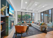 Thumbnail 100 of 105 - a living room with a couch and a fireplace