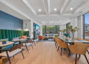 Thumbnail 99 of 105 - a lounge area with tables and chairs and a fireplace