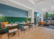 Thumbnail 98 of 105 - a lounge area with tables and chairs and a green couch