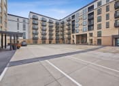 Thumbnail 88 of 105 - an empty parking lot in front of an apartment building