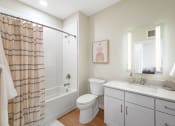 Thumbnail 8 of 105 - a white bathroom with a shower toilet and sink