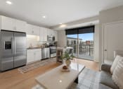 Thumbnail 2 of 105 - a living room with a kitchen and a sliding glass door to a balcony