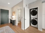 Thumbnail 5 of 105 - a bedroom with a washer and dryer in it and a bathroom with a