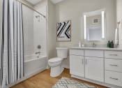 Thumbnail 48 of 105 - a bathroom with white cabinets and a white and black shower curtain