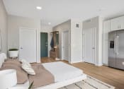 Thumbnail 47 of 105 - a bedroom with a bed and a refrigerator