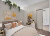 Thumbnail 52 of 105 - a bedroom with a large bed and a door to a bathroom