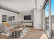 Thumbnail 60 of 105 - a living room with white walls and a sliding glass door that leads to a balcony
