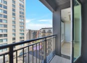 Thumbnail 67 of 105 - a balcony with a door and a view of the city