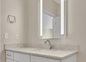 Thumbnail 71 of 105 - a bathroom with a sink and a mirror