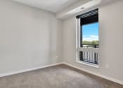 Thumbnail 70 of 105 - a bedroom with a large window and carpet