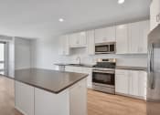 Thumbnail 61 of 105 - a kitchen with white cabinets and stainless steel appliances