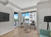 Thumbnail 55 of 105 - a bedroom with a desk and chair in a 555 waverly unit