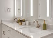 Thumbnail 23 of 105 - a white bathroom with two mirrors and two sinks