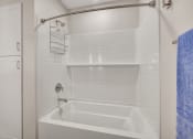 Thumbnail 24 of 105 - a bathroom with a white tub and a white shower curtain