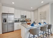 Thumbnail 10 of 105 - a kitchen with white cabinetry and stainless steel appliances