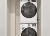 Thumbnail 22 of 105 - a washer and dryer in a small laundry room