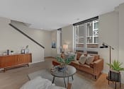 Thumbnail 34 of 105 - a living room with a couch and a table