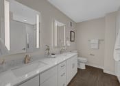 Thumbnail 41 of 105 - a white bathroom with a sink and a toilet