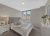 Thumbnail 42 of 105 - a bedroom with a large bed and a window