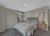 Thumbnail 40 of 105 - a bedroom with a large bed and a window