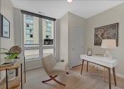 Thumbnail 36 of 105 - a bedroom with a desk and a chair and a window