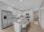 Thumbnail 32 of 105 - a large kitchen with white cabinets and stainless steel appliances