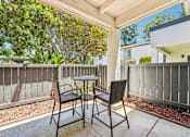 Thumbnail 22 of 129 - A patio with a table and two chairs.