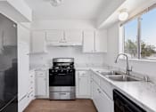Thumbnail 43 of 45 - Kitchen with stainless steel appliances at Ocean Villas Apartments, Oxnard, CA, 93033