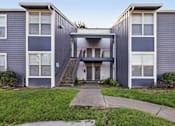 Thumbnail 35 of 47 - A grey building with a white door and windows. at Skyline Heights Apartments, Daly City, California