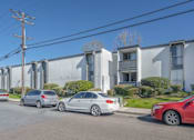 Thumbnail 36 of 39 - a group of cars parked in front of an apartment building at The Arches Apartments, California