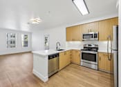 Thumbnail 1 of 60 - A kitchen with wooden cabinets and stainless steel appliances.