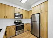Thumbnail 52 of 60 - A kitchen with wooden cabinets and stainless steel appliances.