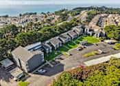 Thumbnail 22 of 47 - A bird's eye view of a residential area with houses and a parking lot. at Skyline Heights Apartments, Daly City