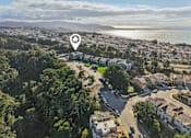 Thumbnail 33 of 47 - A bird's eye view of a residential area with a road running through it. at Skyline Heights Apartments, Daly City, CA