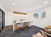 Thumbnail 11 of 45 - Leasing office with desk and chairs at Ocean Villas Apartments, California, 93033