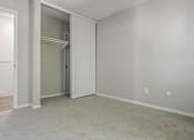 Thumbnail 20 of 39 - an empty living room with an open door to a closet at The Arches Apartments, El Cajon California