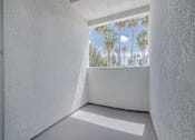 Thumbnail 6 of 23 - a view of palm trees from a window in a white room at Warner Center Townhomes, California