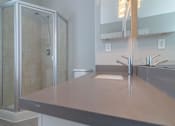 Thumbnail 18 of 23 - a bathroom with a sink and a shower at Warner Center Townhomes, Canoga Park California