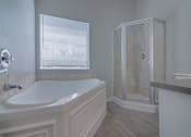 Thumbnail 19 of 23 - a white bathroom with a tub and a shower at Warner Center Townhomes, Canoga Park, 91303