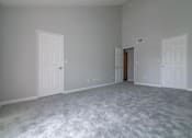 Thumbnail 20 of 23 - a bedroom with a carpeted floor and two doors at Warner Center Townhomes, California