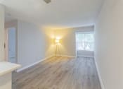 Thumbnail 6 of 47 - an empty living room with wood floors and a window at Skyline Heights Apartments, California