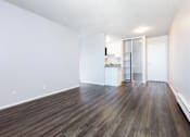 Thumbnail 12 of 47 - an empty living room with white walls and wood floors at Skyline Heights Apartments, California