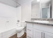 Thumbnail 15 of 47 - a white bathroom with a sink and a toilet at Skyline Heights Apartments, California, 94015