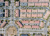 Thumbnail 12 of 45 - a birdseye view of a street intersection with cars and houses at The Vines at Riverpark, LLC, Oxnard