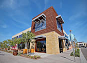 Thumbnail 14 of 45 - a building with a clock on the front of it at The Vines at Riverpark, LLC, Oxnard, CA 93036