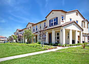 Thumbnail 16 of 45 - a row of houses on the side of a green lawn at The Vines at Riverpark, LLC, Oxnard California