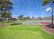 Thumbnail 17 of 45 - a basketball court in the middle of a park at The Vines at Riverpark, LLC, Oxnard California