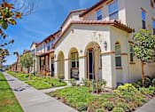Thumbnail 23 of 45 - a row of houses with a sidewalk in front of them at The Vines at Riverpark, LLC, Oxnard, 93036