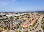 Thumbnail 26 of 45 - an aerial view of a suburb of a city with cars on the street at The Vines at Riverpark, LLC, California, 93036