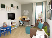Thumbnail 5 of 45 - a living room with a couch and a desk and a tv at The Vines at Riverpark, LLC, Oxnard